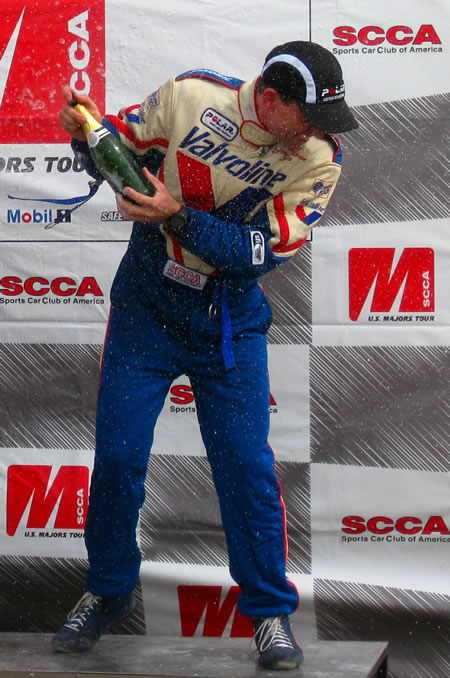 Larry gets a champagne shower on the podium Sunday.