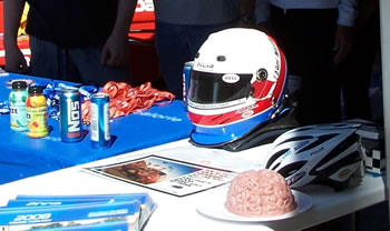 A Jell-O brain and two different types of head protection, Larry Mason's Bell auto racing and Bell bicycle helmet.